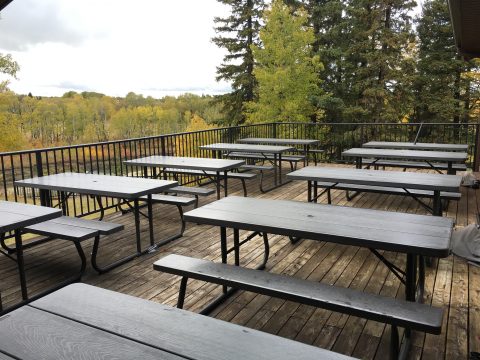Off the dining room is a spacious deck with picnic tables that overlooks the river below.
